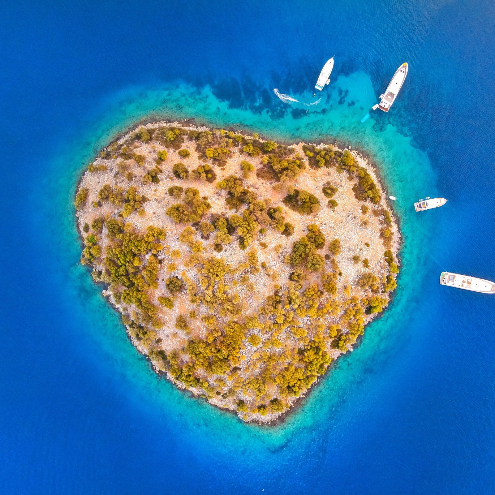 an island with boats in the water